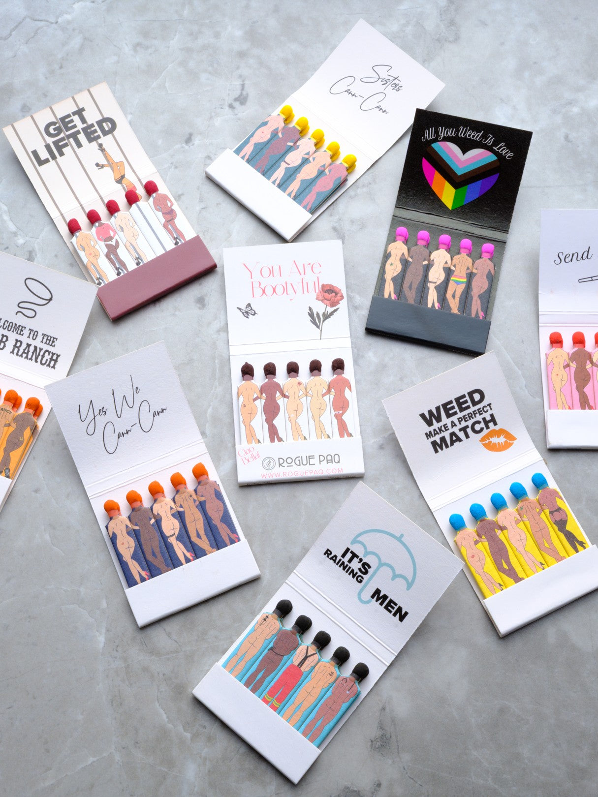 A curated bundle of all 9 styles of Rogue Paq SendNudes matchbooks. The bundle includes three books of each of the 9 matchbook styles featured here. The books, feature diverse, artistic pin-up figures in high-kick dance poses. Each matchbook has its own uplifting saying inside.