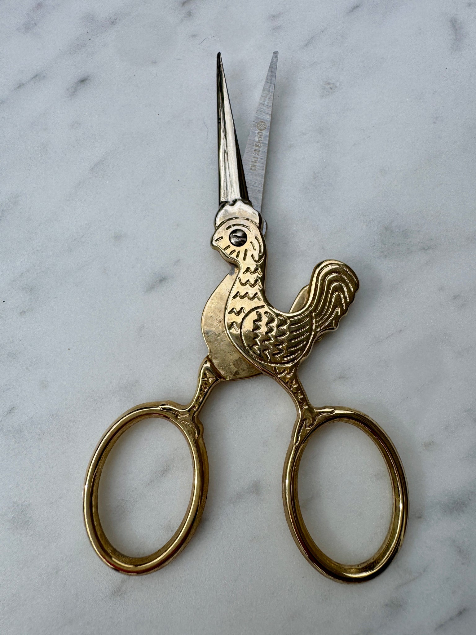 Small utility scissors with a whimsical rooster design make your ritual lighter and more fun.