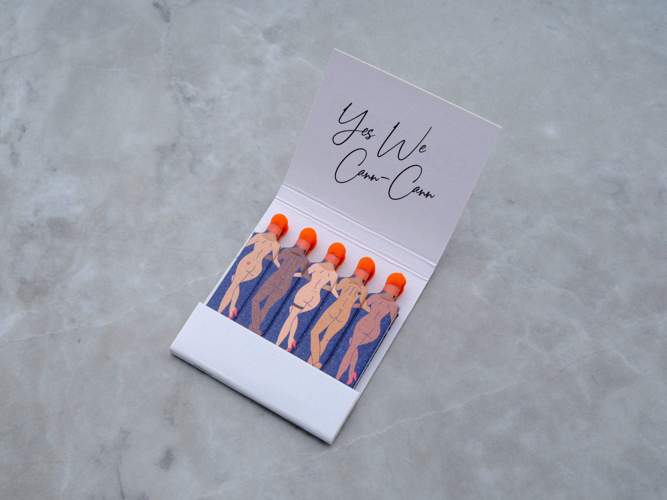Open book of Yes We Cann Cann novelty safety matches to show the thoughtful design and commitment to detail. The diverse bodies and skintones celebrate an inclusive and welcoming ritual for all.