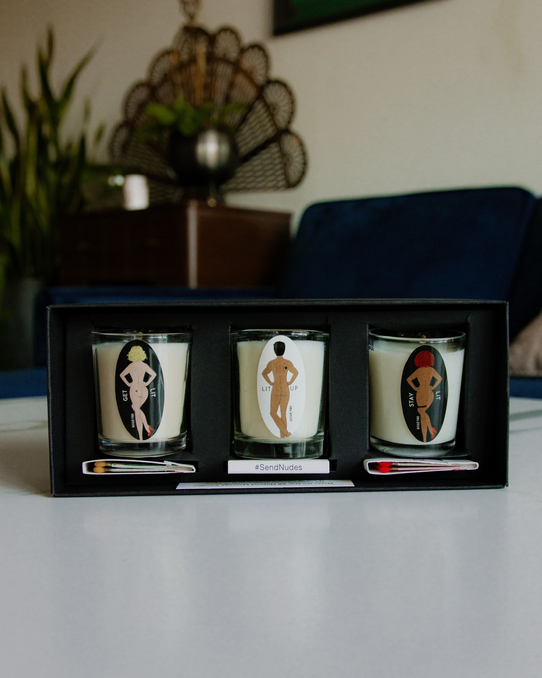 Three organic massage candles and 3 SendNudes matches in the matte black gift box.