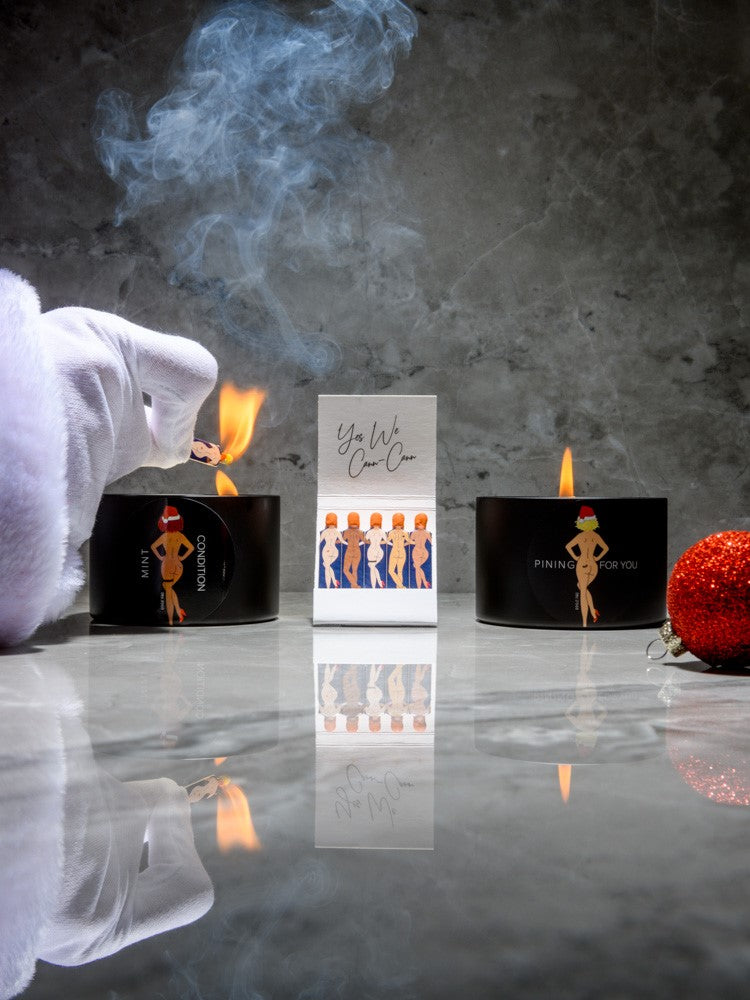 Rogue Paq 'Pining For You' and 'Mint Condition' holiday scented soy candles in a seamless tin vessel; featuring vintage-style pin-up art with festive Santa Hat details