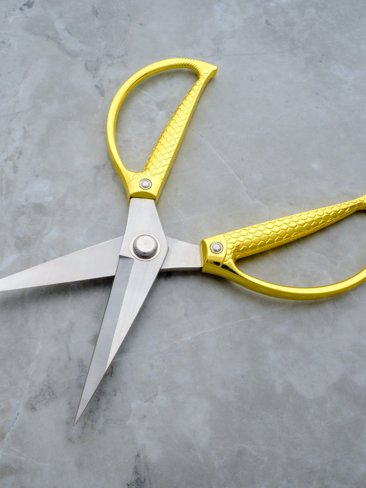 Rogue Paq XL gold cannabis trimming and harvesting scissors for a refined smoking ritual.